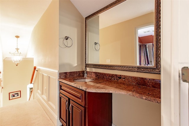 bathroom with vanity and lofted ceiling