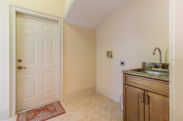 laundry room with electric dryer hookup, cabinets, sink, hookup for a washing machine, and light tile patterned floors