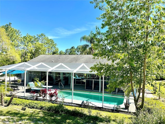 view of swimming pool with a patio area and a lanai