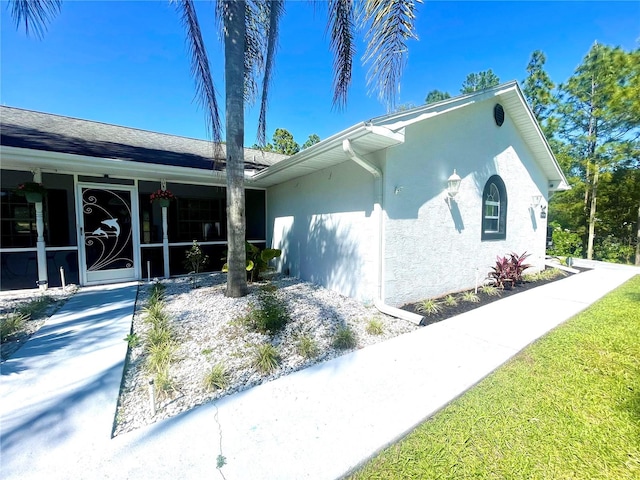 view of side of property with a sunroom