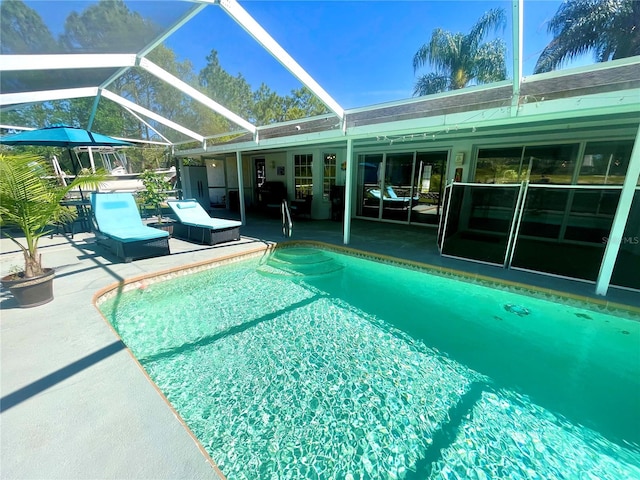 view of swimming pool with a lanai and a patio area