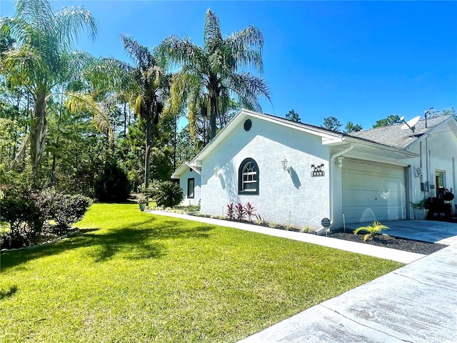 view of property exterior with a yard and a garage