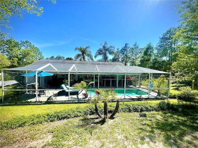 rear view of house with a patio and glass enclosure