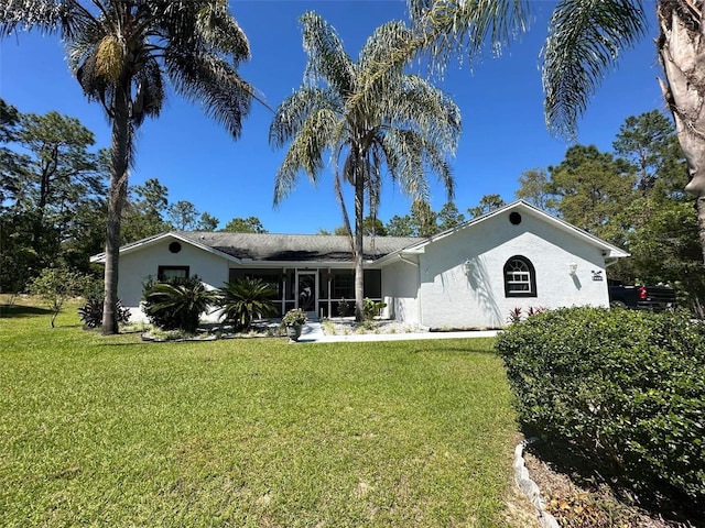 back of house with a sunroom and a yard