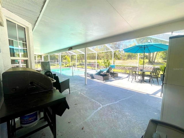 view of patio / terrace featuring a grill and glass enclosure