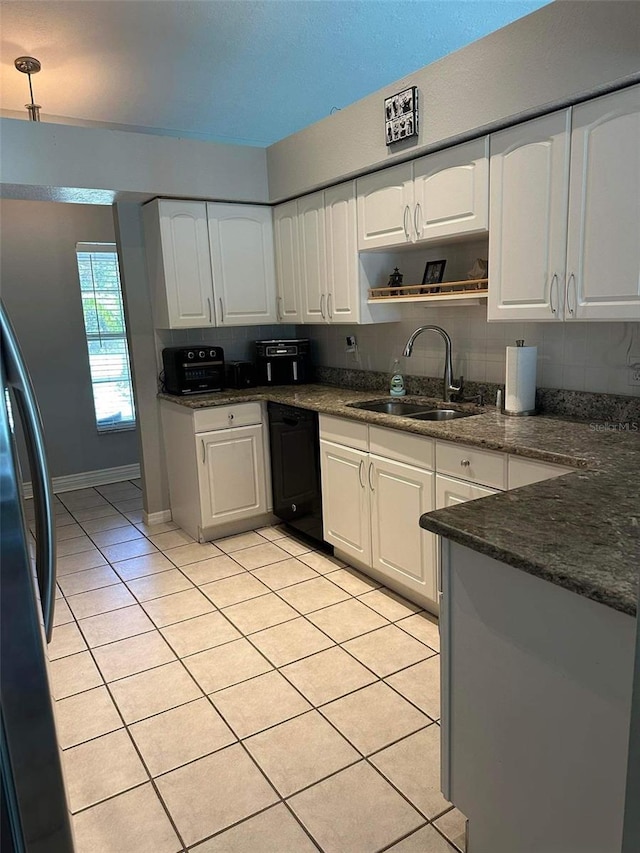 kitchen featuring white cabinets, decorative backsplash, dishwasher, and sink