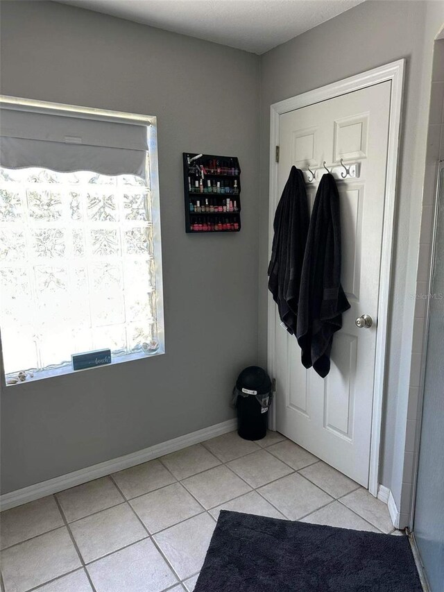 doorway to outside featuring light tile patterned flooring