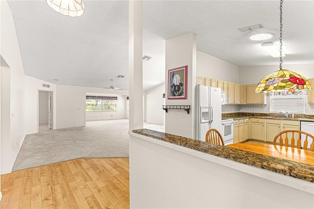 kitchen with white appliances, light colored carpet, ceiling fan, sink, and cream cabinets