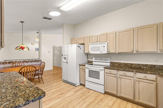 kitchen with a textured ceiling, white appliances, decorative light fixtures, and light brown cabinets