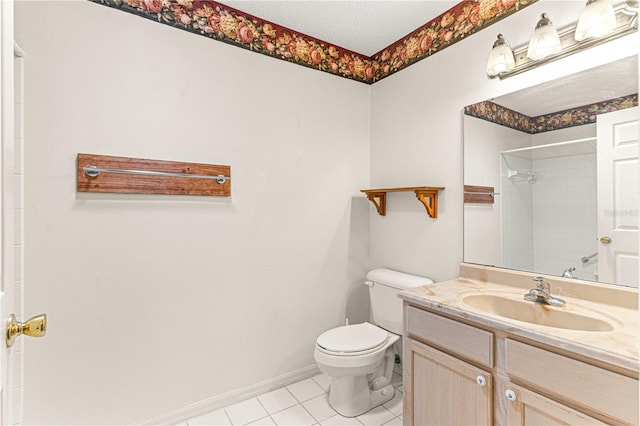 bathroom featuring a shower, tile patterned floors, vanity, and toilet