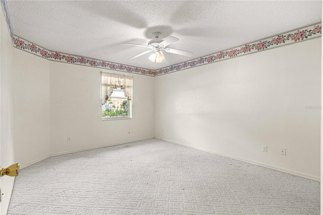 unfurnished room featuring ceiling fan and a textured ceiling