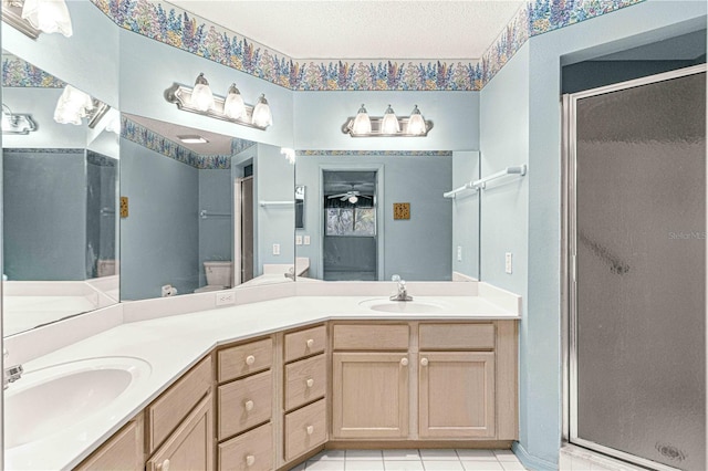 bathroom featuring vanity, tile patterned floors, an enclosed shower, and ceiling fan