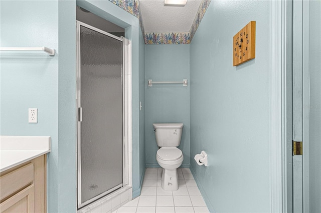 bathroom featuring a textured ceiling, vanity, tile patterned flooring, toilet, and a shower with shower door