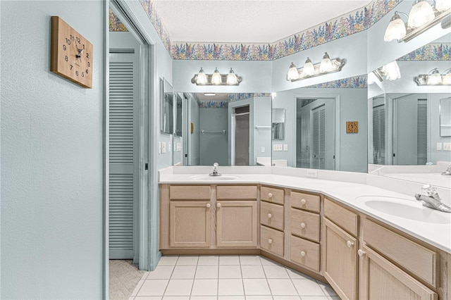 bathroom featuring tile patterned flooring, a textured ceiling, and vanity