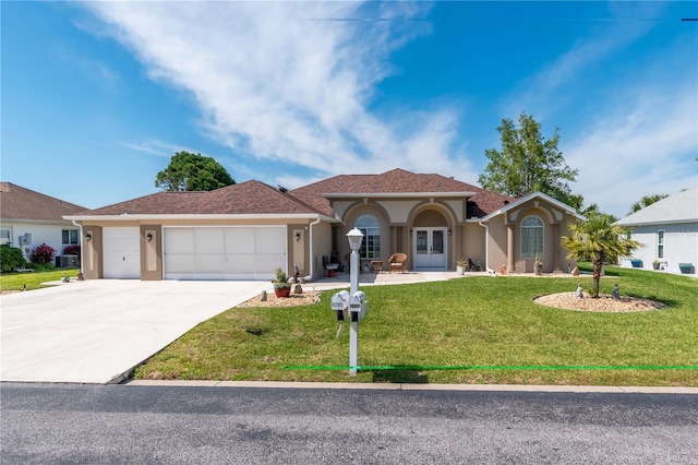 view of front of home featuring a garage and a front lawn