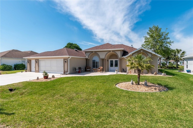 mediterranean / spanish home featuring a garage and a front lawn