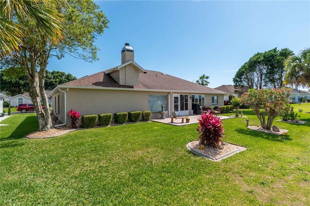 back of house featuring a patio area and a yard