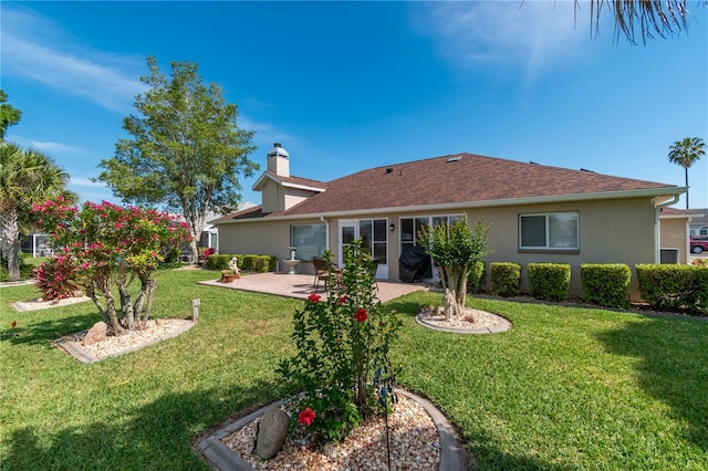 back of property with a lawn and a patio area