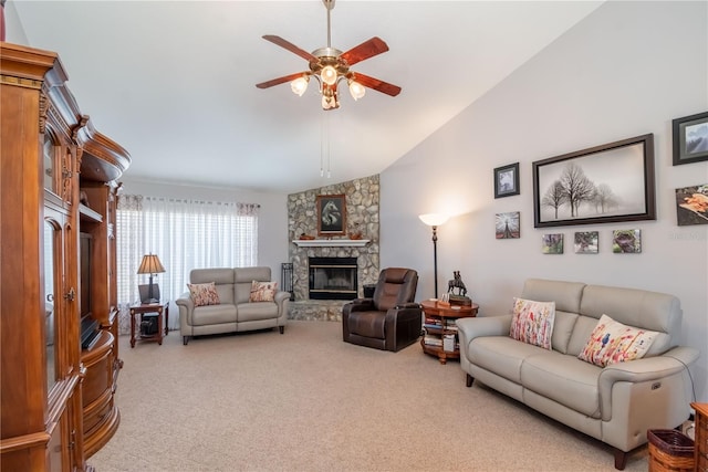 carpeted living room featuring a stone fireplace, ceiling fan, and vaulted ceiling