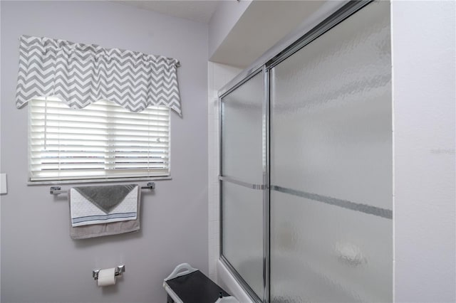 bathroom featuring bath / shower combo with glass door