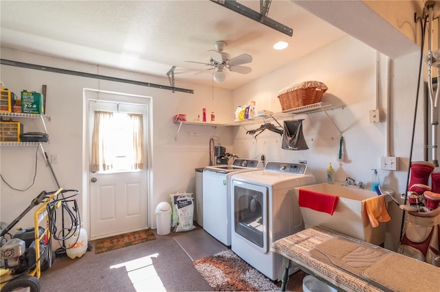 laundry room featuring dark carpet, ceiling fan, sink, and washer and dryer