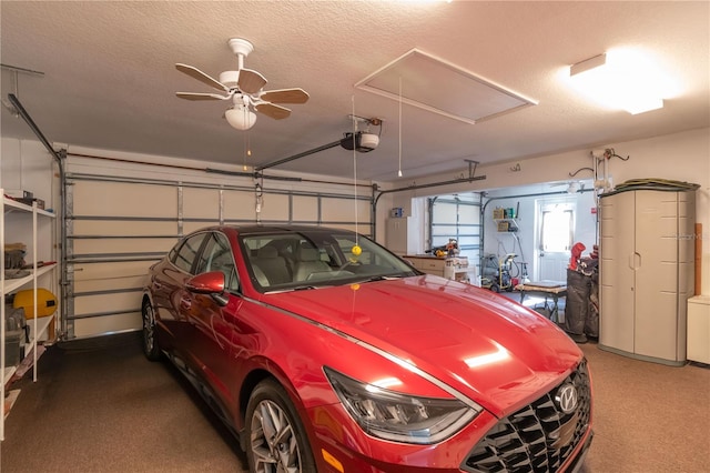 garage with ceiling fan and a garage door opener