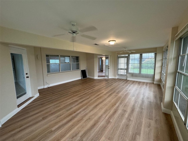 unfurnished living room with hardwood / wood-style floors and ceiling fan