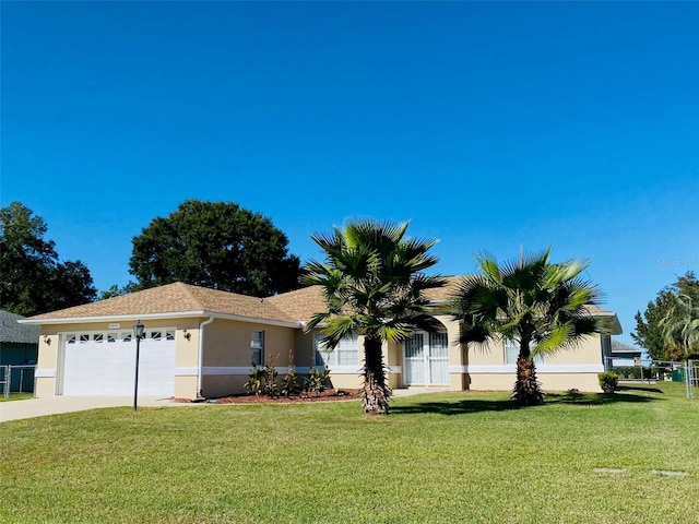 single story home featuring a garage and a front lawn