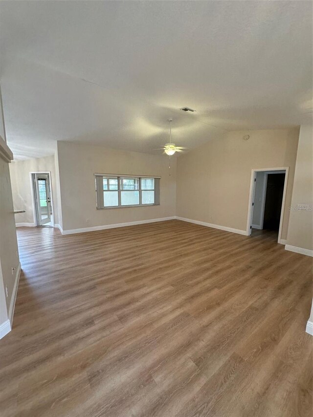 unfurnished living room featuring ceiling fan and wood-type flooring