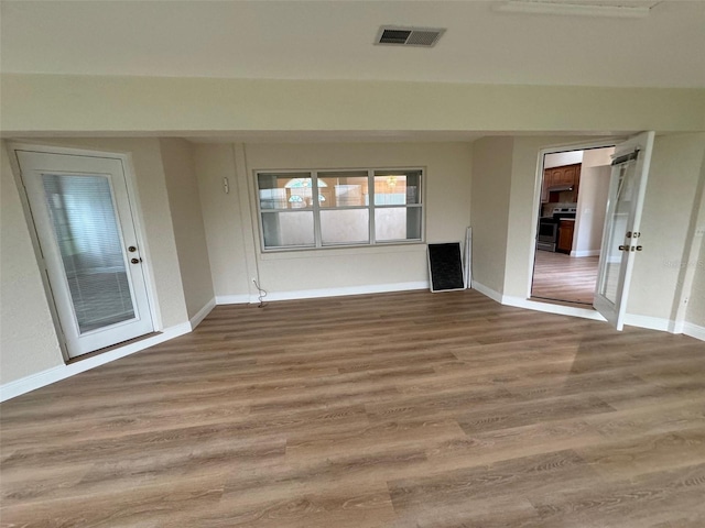 unfurnished living room featuring hardwood / wood-style flooring