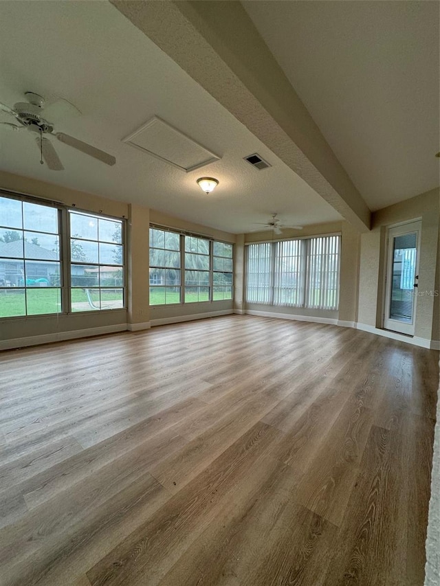 unfurnished living room with ceiling fan and hardwood / wood-style flooring