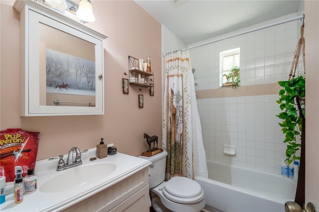 full bathroom with vanity, toilet, and shower / bath combo with shower curtain