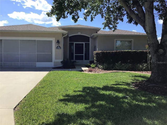 ranch-style home featuring a garage and a front yard