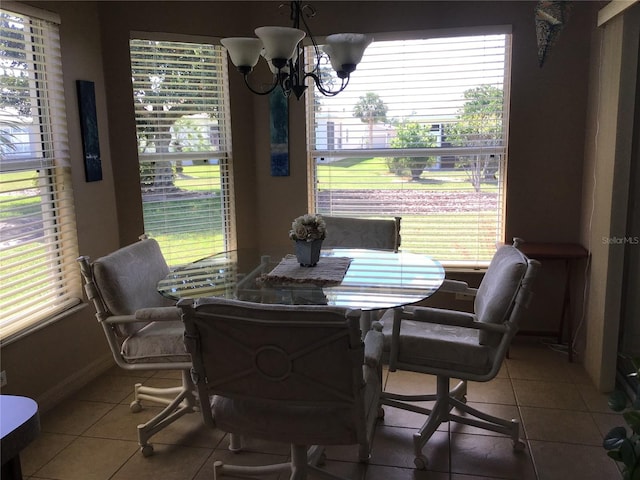 tiled dining space featuring a notable chandelier