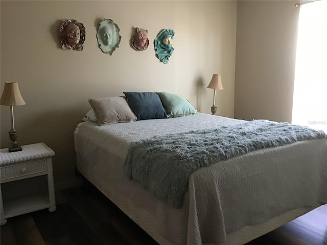 bedroom with dark hardwood / wood-style floors