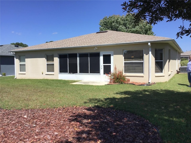 rear view of property with a lawn