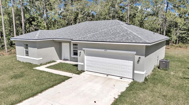 ranch-style home featuring central AC unit, a garage, and a front yard