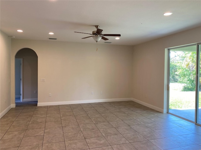 tiled spare room featuring a healthy amount of sunlight and ceiling fan