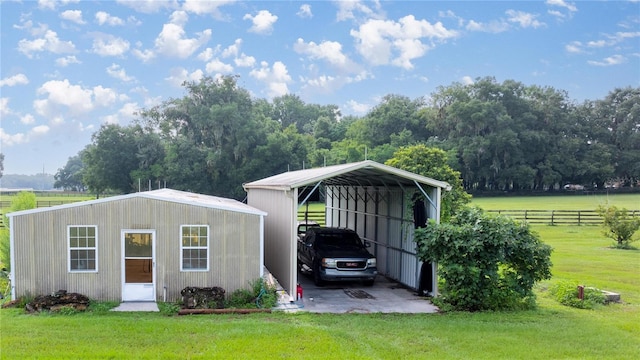 view of outdoor structure featuring a carport and a lawn