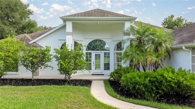 property entrance with a yard and french doors