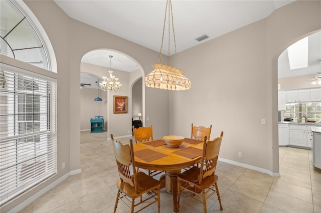 dining room featuring sink, ceiling fan with notable chandelier, and light tile patterned floors