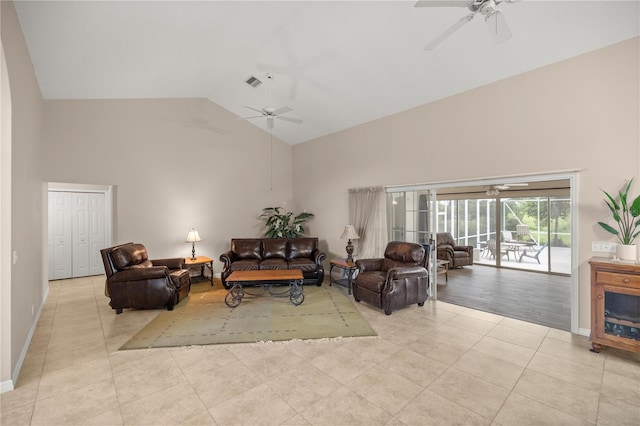 tiled living room with high vaulted ceiling and ceiling fan