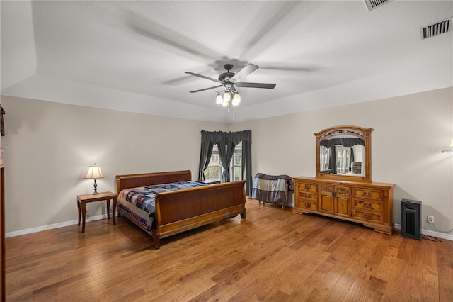 bedroom with light hardwood / wood-style floors and ceiling fan