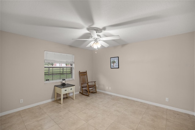 sitting room with light tile patterned flooring and ceiling fan