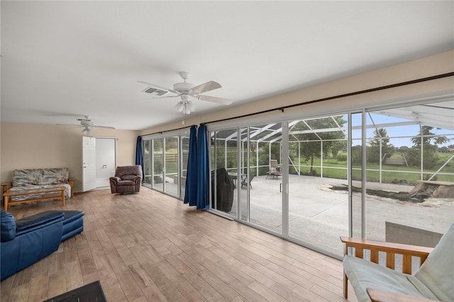 living room with wood-type flooring and ceiling fan