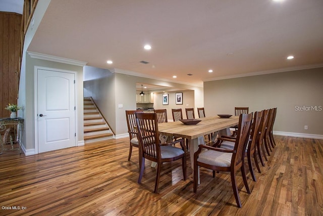 dining room featuring hardwood / wood-style floors and crown molding