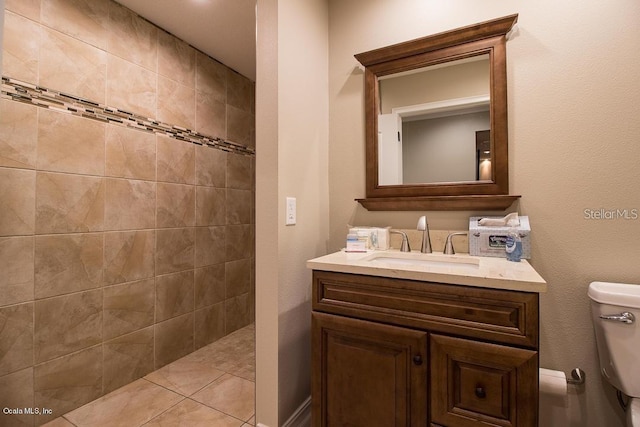 bathroom featuring tiled shower, vanity, and toilet