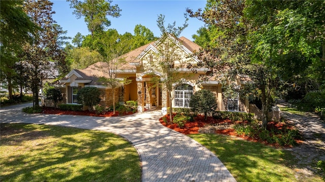 mediterranean / spanish-style home with a front yard