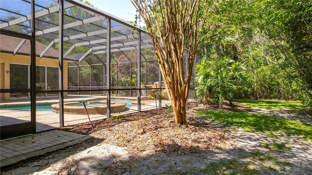 view of yard featuring a patio area and glass enclosure