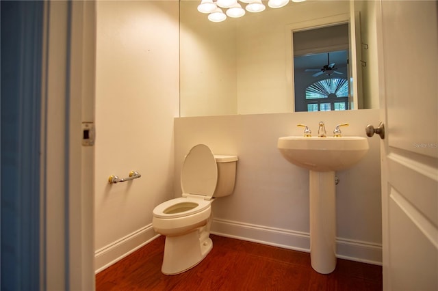 bathroom with ceiling fan, toilet, and hardwood / wood-style flooring